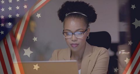 Focused African American Businesswoman Working on Laptop with USA Flag Overlay