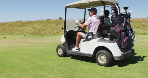 Senior Couple Enjoying Golf Cart Ride on Course with Clubs - Download Free Stock Images Pikwizard.com