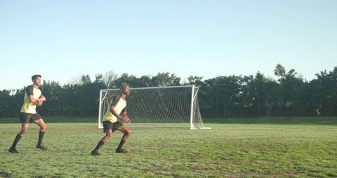 Young Soccer Players Enjoying Team Practice Outdoors on Sunny Day