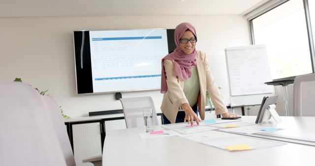 Confident Businesswoman Presenting Analytics in Modern Office - Download Free Stock Images Pikwizard.com