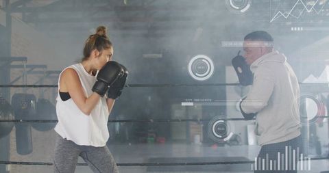 Female boxer training with coach in boxing ring, focus mitt drills and analytics overlay