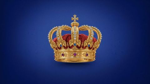 Golden british empire regal crown with jewels on deep blue backdrop