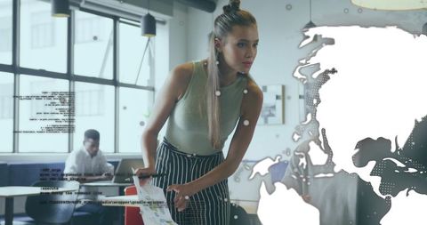 Professional Woman Analyzing Charts Amidst Technological Innovations