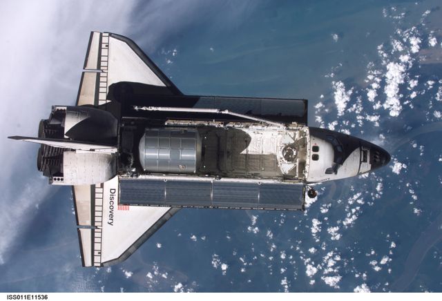 Launched on July 26 2005 from the Kennedy Space Center in Florida, STS-114 was classified as Logistics Flight 1. Among the Station-related activities of the mission were the delivery of new supplies and the replacement of one of the orbital outpost's Control Moment Gyroscopes (CMGs). STS-114 also carried the Raffaello Multi-Purpose Logistics Module (MPLM) and the External Stowage Platform-2.  Back dropped by popcorn-like clouds, the MPLM can be seen in the cargo bay as Discovery undergoes rendezvous and docking operations. Cosmonaut Sergei K. Kriklev, Expedition 11 Commander, and John L. Phillips, NASA Space Station officer and flight engineer photographed the spacecraft from the International Space Station (ISS).