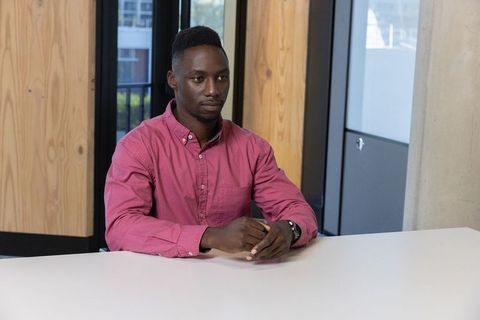 Young African American Man in Modern Meeting Room