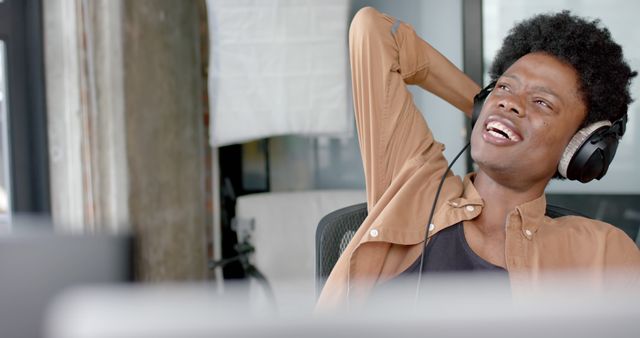 Relaxed Young Man Enjoying Music in Office - Download Free Stock Images Pikwizard.com