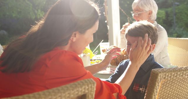 Mother Consoling Son During Family Outdoor Meal - Download Free Stock Images Pikwizard.com