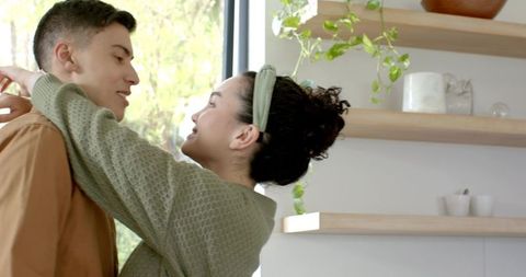 Happy Couple Hugging in Cozy Modern Living Room with Plants