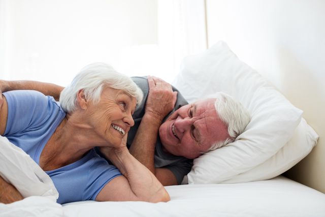Senior couple relaxing in the bedroom at home