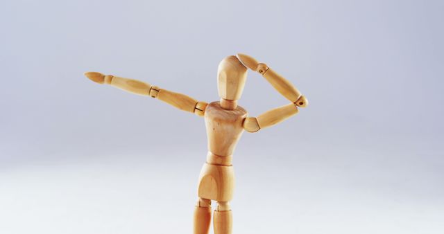 Wooden art mannequin striking a dynamic pose against a white background. Useful for illustrating concepts of creativity, art, motion, and artistic expression in various visual projects. Suitable for use in educational materials, arts and crafts promotions, and design inspiration.