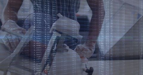 Technician adjusting equipment with data overlay in workshop