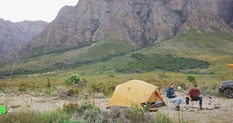 Mountainside Camping Adventure with Tent and SUV