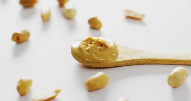 Smooth Peanut Butter on Wooden Spoon with Peanuts - Download Free Stock Images Pikwizard.com