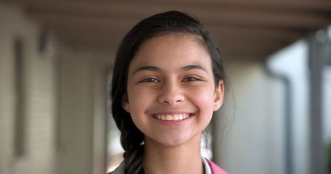 Smiling Teen Girl Posing Outdoors on Covered Porch