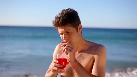 Man Enjoying Refreshing Cocktail Drink By Ocean