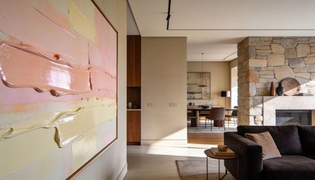 Contemporary open-plan living dining with oversized pastel impasto painting and fireplace