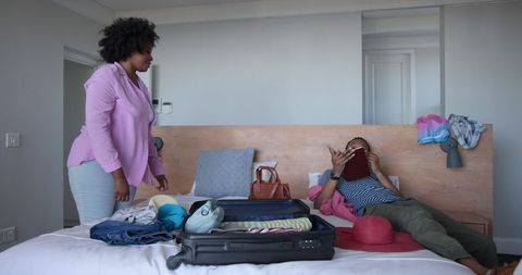 Couple Packing Suitcase for Travel Adventure
