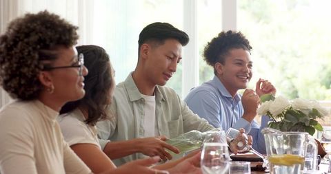 Friends Enjoying Drinks and Conversation at Wedding Reception