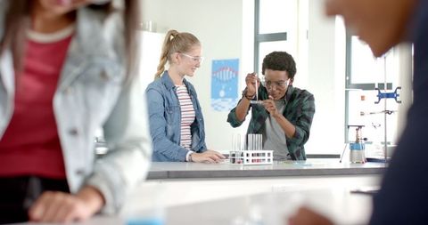 High School Students Engaged in Chemistry Experiment