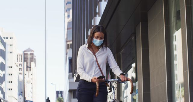 Woman Walking Bicycle on Urban Street Wearing Face Mask - Download Free Stock Images Pikwizard.com