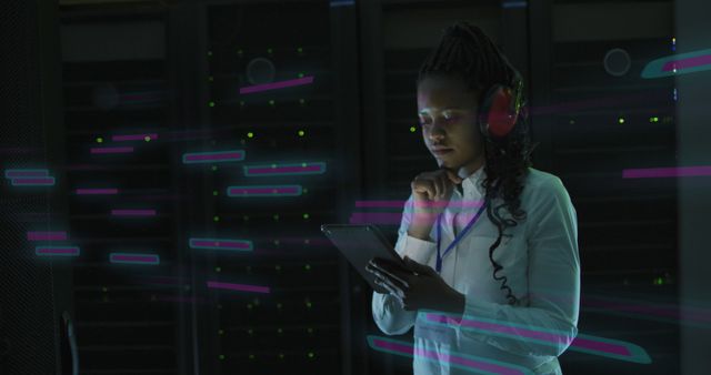 Illustrating a woman in a server room analyzing data on a tablet. She is wearing headphones, indicating she is concentrating on her work in cybersecurity or network management. This image is ideal for content related to technology, information security, and digital transformation in the workplace.