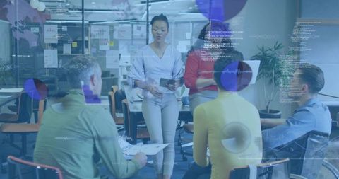 Female leader guiding data-driven brainstorming with digital analytics overlays in open office