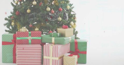 Festive christmas tree with stacked wrapped gifts in red green gold for holiday promotions