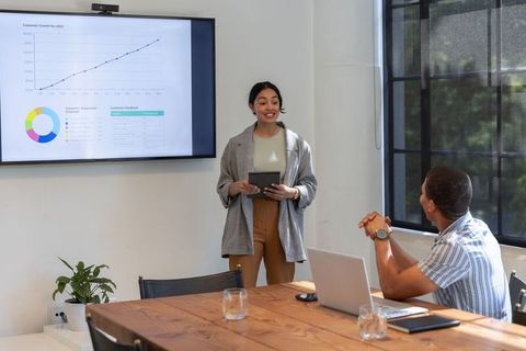 Diverse team analyzing growth chart in conference room