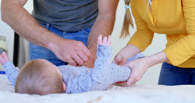 Parents Changing Baby's Diaper in Comfortable Home Setting - Download Free Stock Images Pikwizard.com