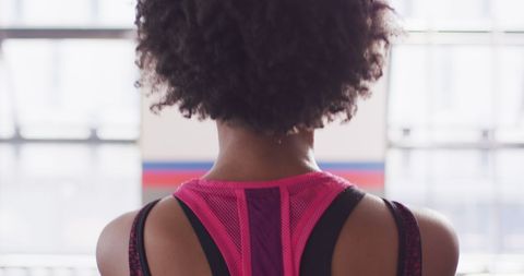 Rear View of Woman Exercising with Kettlebell at Gym