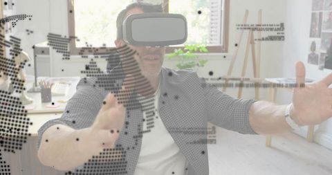 Man using vr headset manipulating holographic world map overlay in modern home office desk