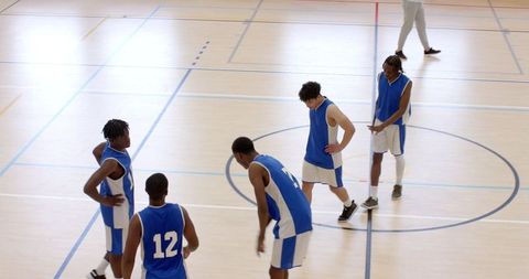 Diverse Male Athletes Preparing on Basketball Court