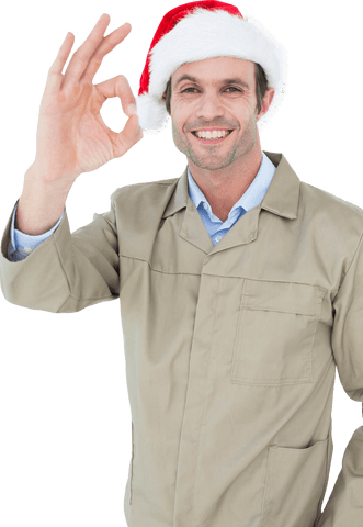 Smiling delivery man in santa hat giving ok gesture transparent