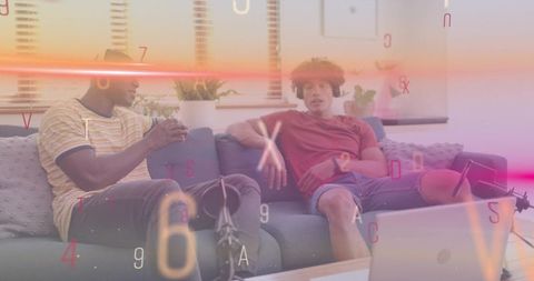 Two Friends Recording Casual Podcast on Sofa with Laptop, Microphone and Home Plants