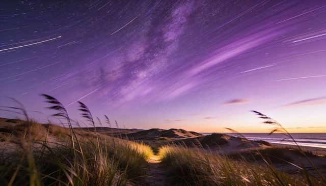 Twilight milky way arcing over coastal sand dunes with leading footpath and star trails