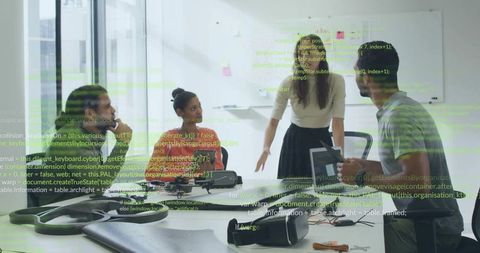 Female leader guiding team around table with vr headsets during collaborative tech meeting