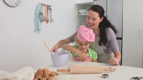 Mother and Daughter Bonding While Baking in Home Kitchen