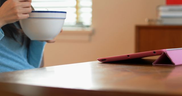 Woman Eating Breakfast Watching Tablet Near Window - Download Free Stock Images Pikwizard.com