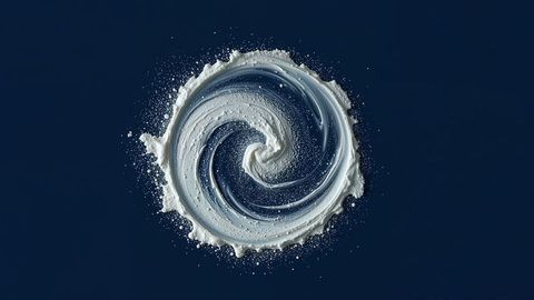 Abstract white cream spiral on deep blue background