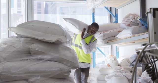 Warehouse Worker Carrying Heavy Sack Wearing Safety Vest - Download Free Stock Images Pikwizard.com