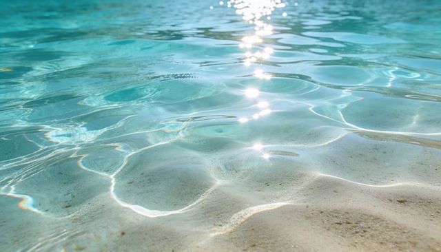 Shimmering Turquoise Shallow Water Over Pale Sandy Seabed with Sunlight Caustics