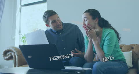 Caucasian Couple Anxiously Using Laptop With Data Overlay