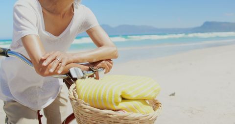 Senior Woman Enjoying a Day at the Beach with Bicycle - Download Free Stock Images Pikwizard.com
