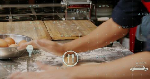 Hands Kneading Dough in Kitchen with Digital Overlay Icons