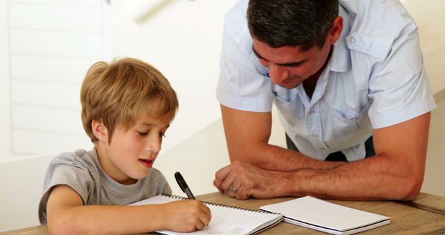 Father Helping Son with Homework at Home in Living Room - Download Free Stock Images Pikwizard.com