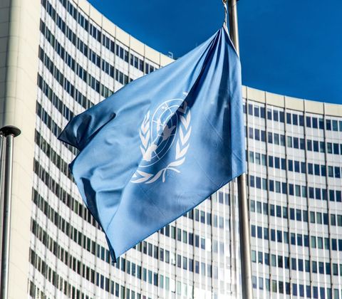 United Nations Flag Flying in Front of Modern Building