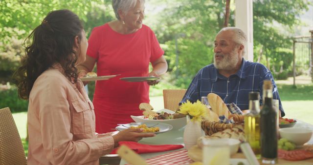 Multi-Generational Family Enjoying Outdoor Meal Together in Backyard - Download Free Stock Images Pikwizard.com