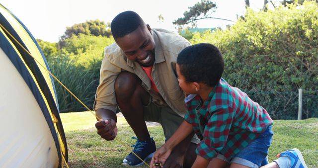 Father and Son Setting Up Tent on Camping Trip in Park - Download Free Stock Images Pikwizard.com