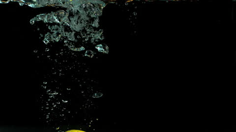 Lemon Splashing into Water with Elegance in Slow Motion