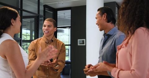 Diverse Team Celebrating Successful Collaboration in Office